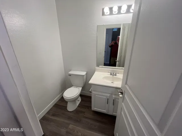 a bathroom with a toilet sink and mirror