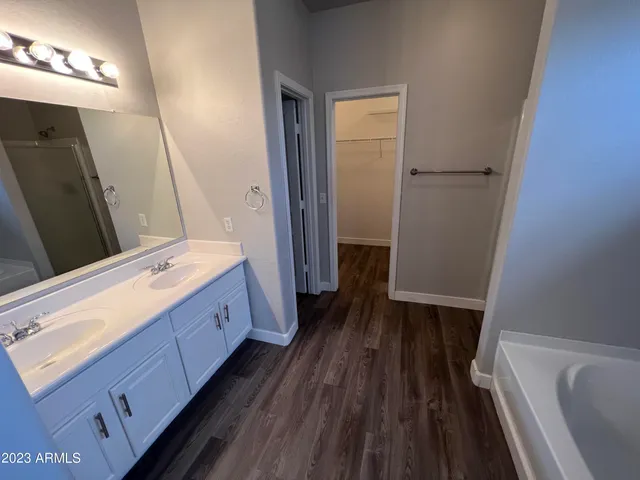 a bathroom with a double vanity sink and a mirror