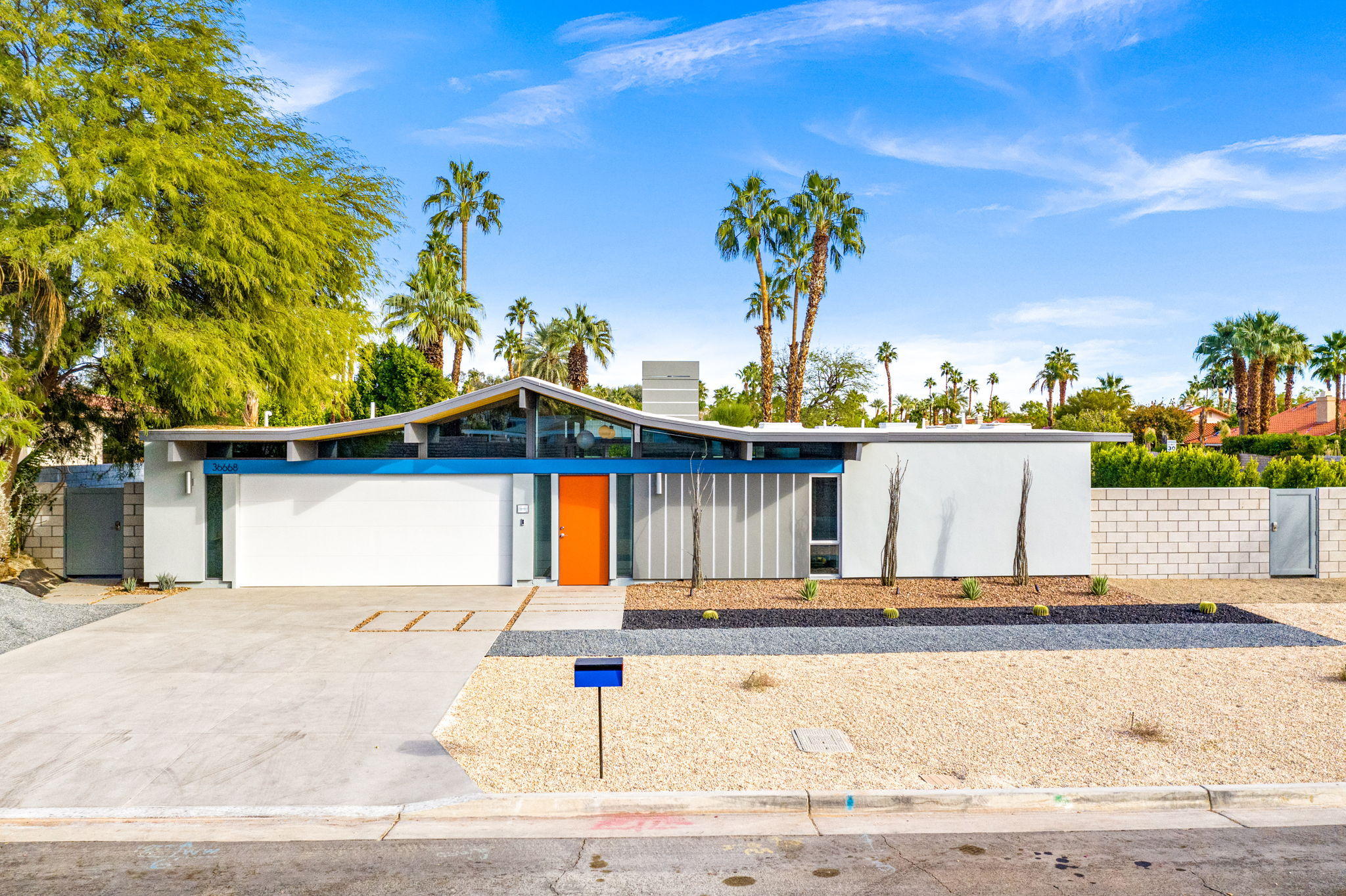 36668 Palm View Road Rancho Mirage, CA 92270 - Photo 2 of 49 a front view of a house with a yard and trees