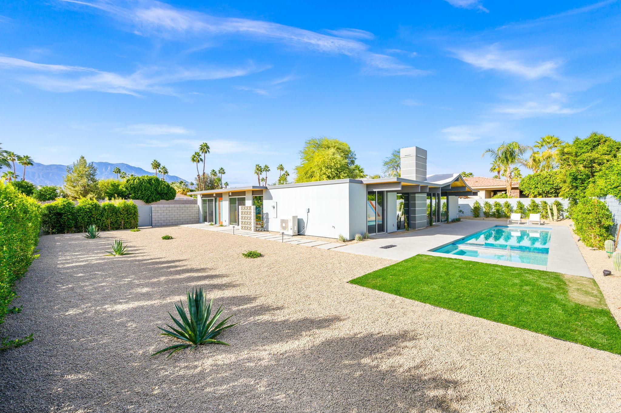 36668 Palm View Road Rancho Mirage, CA 92270 - Photo 38 of 49 a view of a house with a swimming pool and a yard
