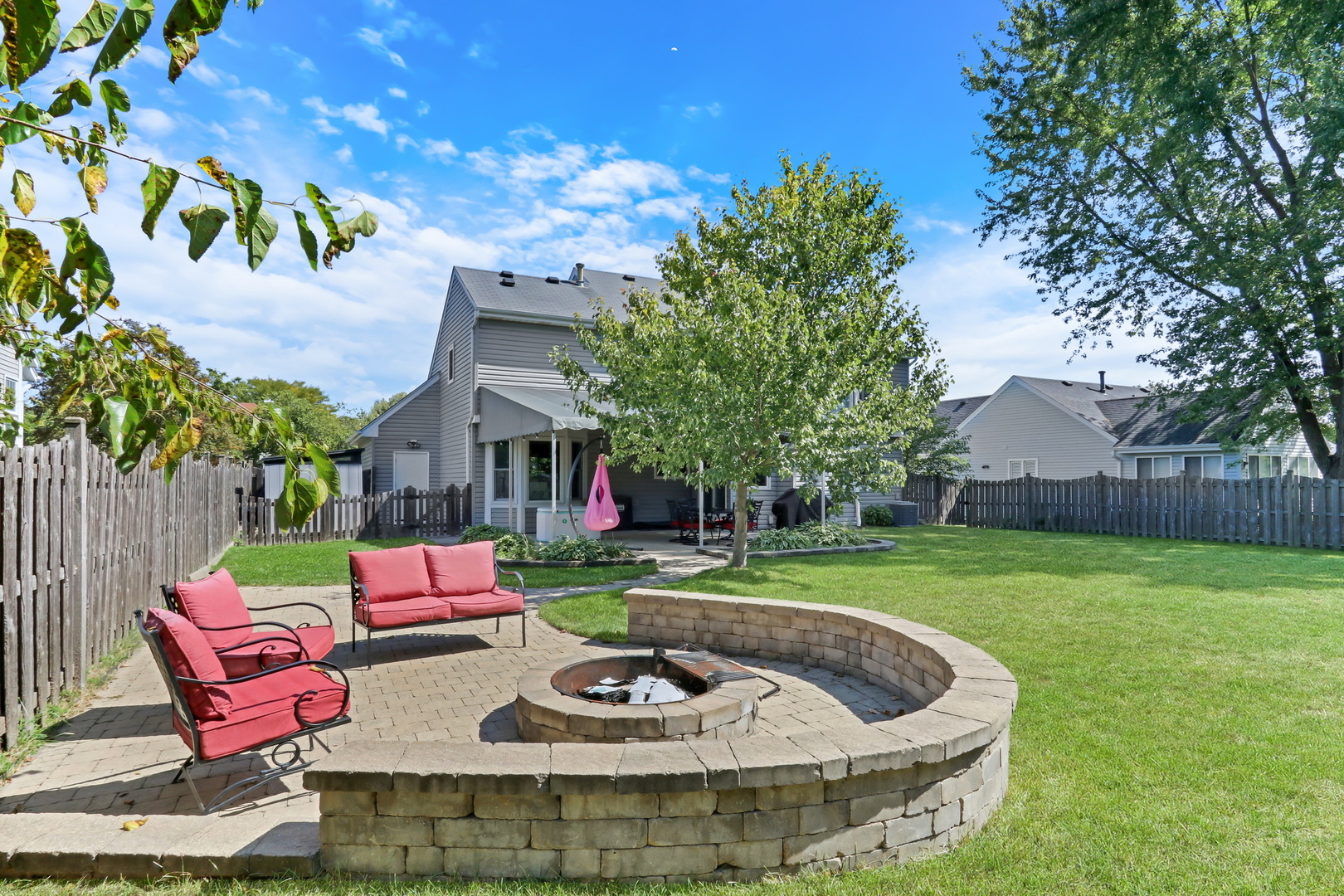 6183 Old Farm Lane Gurnee, IL 60031 - Photo 18 of 52 a view of a backyard with table and chairs potted plants and a large tree
