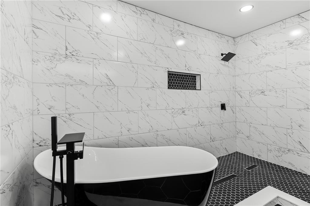 968 Bruce Circle Southeast Atlanta, GA 30316 - Photo 14 of 40 a bathroom with a bathtub and shower
