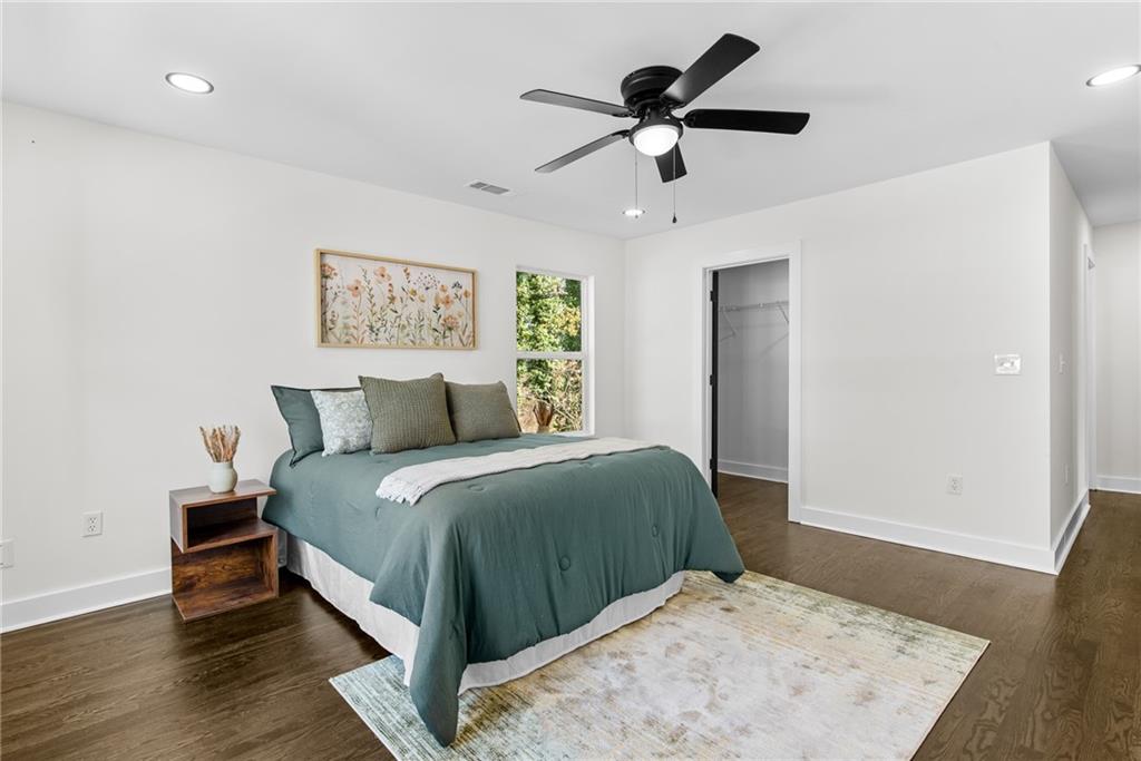 968 Bruce Circle Southeast Atlanta, GA 30316 - Photo 17 of 40 a bedroom with a large bed and a wooden floor