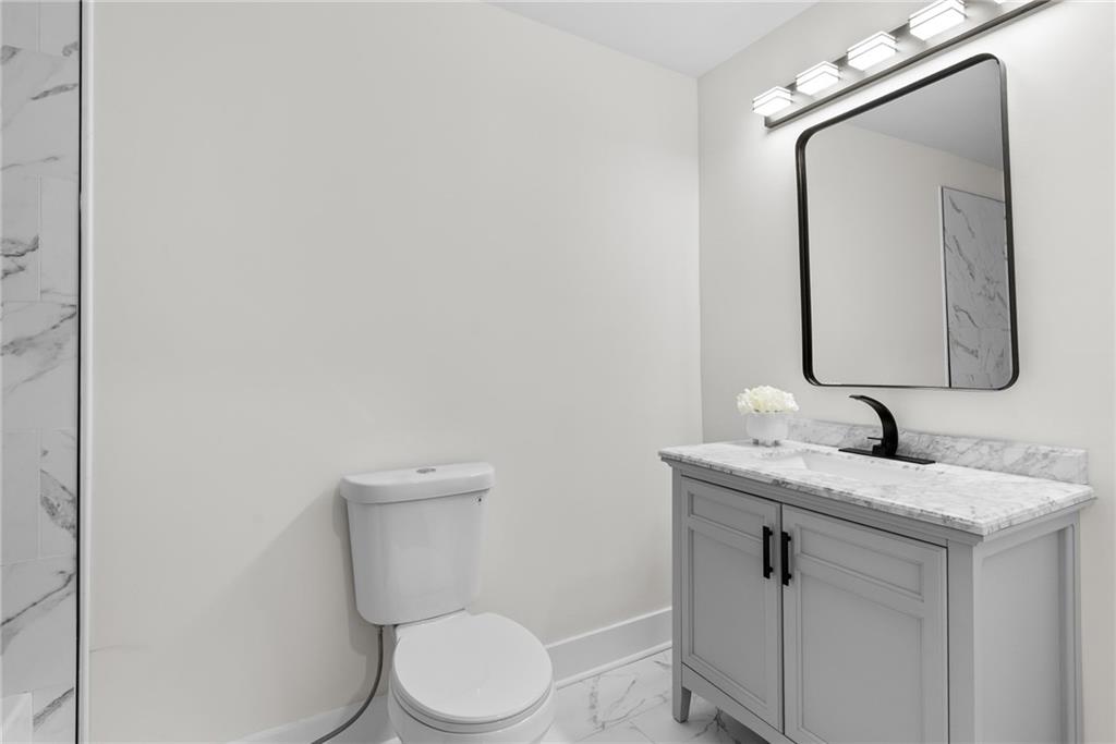 968 Bruce Circle Southeast Atlanta, GA 30316 - Photo 23 of 40 a bathroom with a toilet sink and mirror