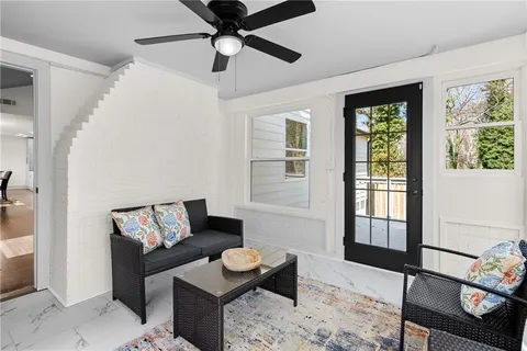 a living room with furniture and wooden floor