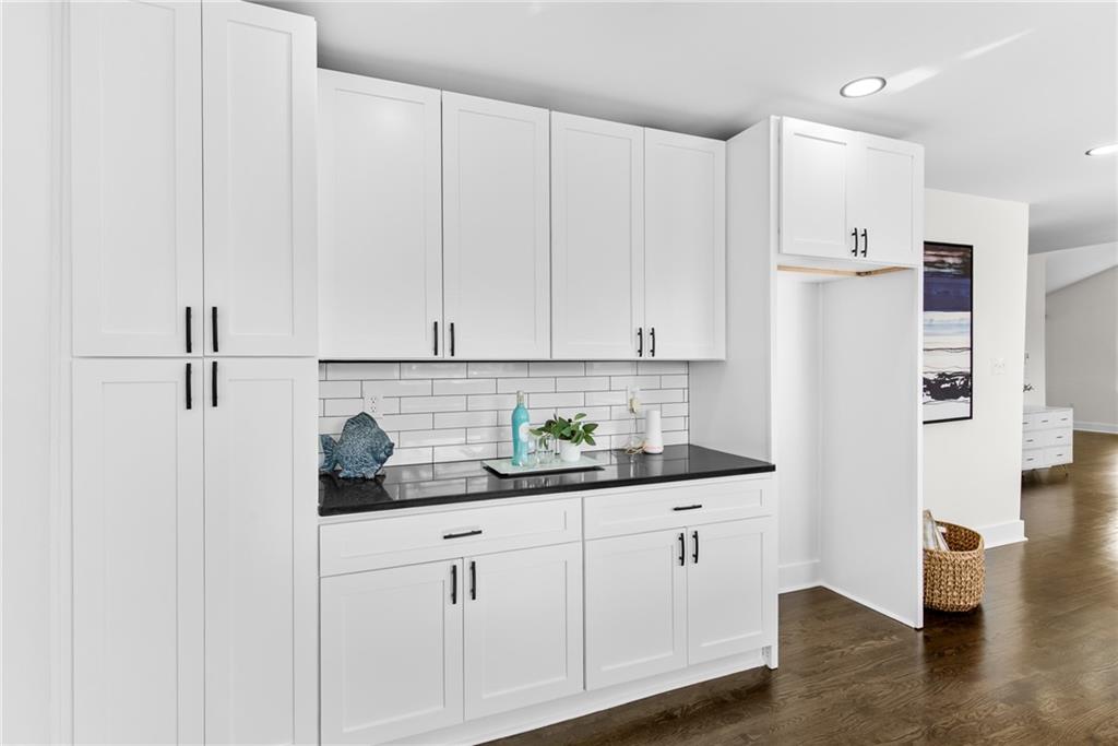 968 Bruce Circle Southeast Atlanta, GA 30316 - Photo 10 of 40 a kitchen with stainless steel appliances white cabinets and wooden floors