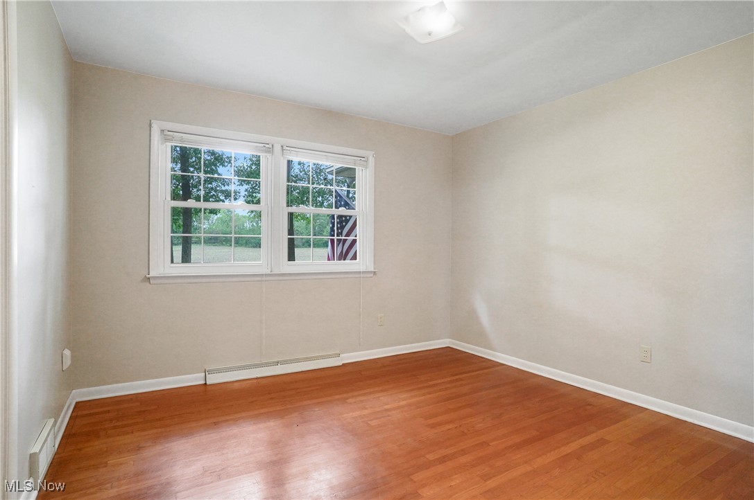 449 East Comet Road Clinton, OH 44216 - Photo 31 of 39 3rd Bedroom with hardwood / wood-style flooring and a baseboard radiator