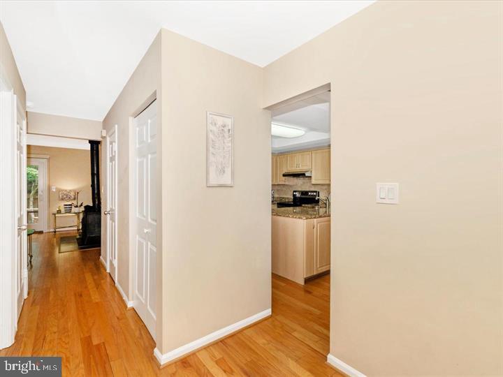 20105 Waringwood Way Gaithersburg, MD 20886 - Photo 11 of 39 a view of a hallway with bathroom and wooden floor