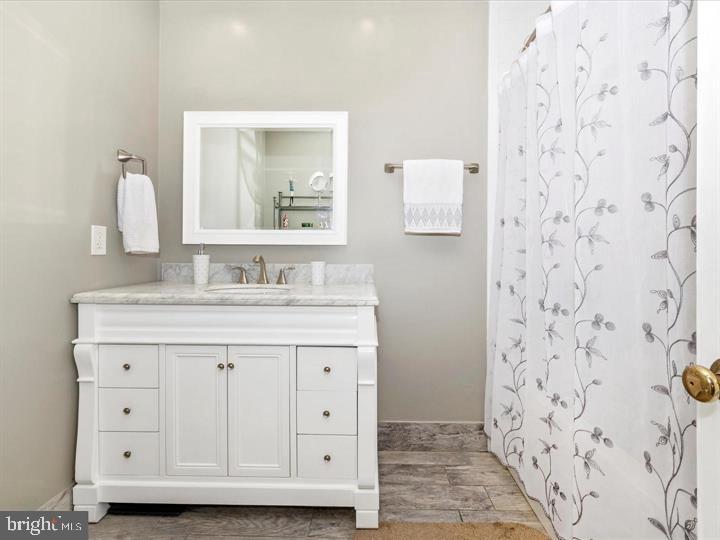 20105 Waringwood Way Gaithersburg, MD 20886 - Photo 17 of 39 a bathroom with a granite countertop sink a mirror and shower