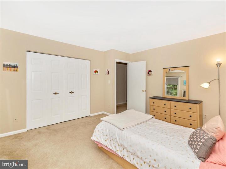 20105 Waringwood Way Gaithersburg, MD 20886 - Photo 18 of 39 a bedroom with a bed and a dresser
