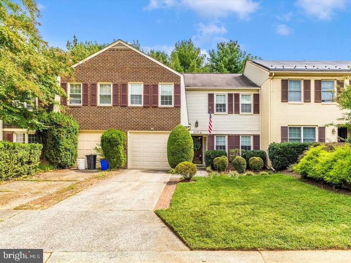 20105 Waringwood Way Gaithersburg, MD 20886 - Photo 2 of 39 a front view of a house with garden