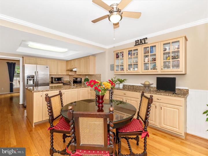 20105 Waringwood Way Gaithersburg, MD 20886 - Photo 4 of 39 a view of a dining room with furniture a kitchen and chandelier