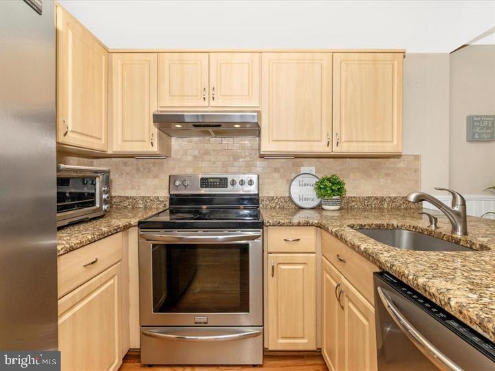 20105 Waringwood Way Gaithersburg, MD 20886 - Photo 8 of 39 a kitchen with granite countertop a sink stainless steel appliances and cabinets