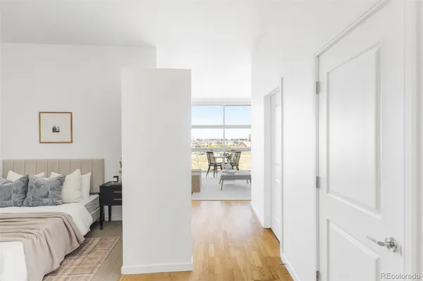 a view of a building with a large window and sitting area
