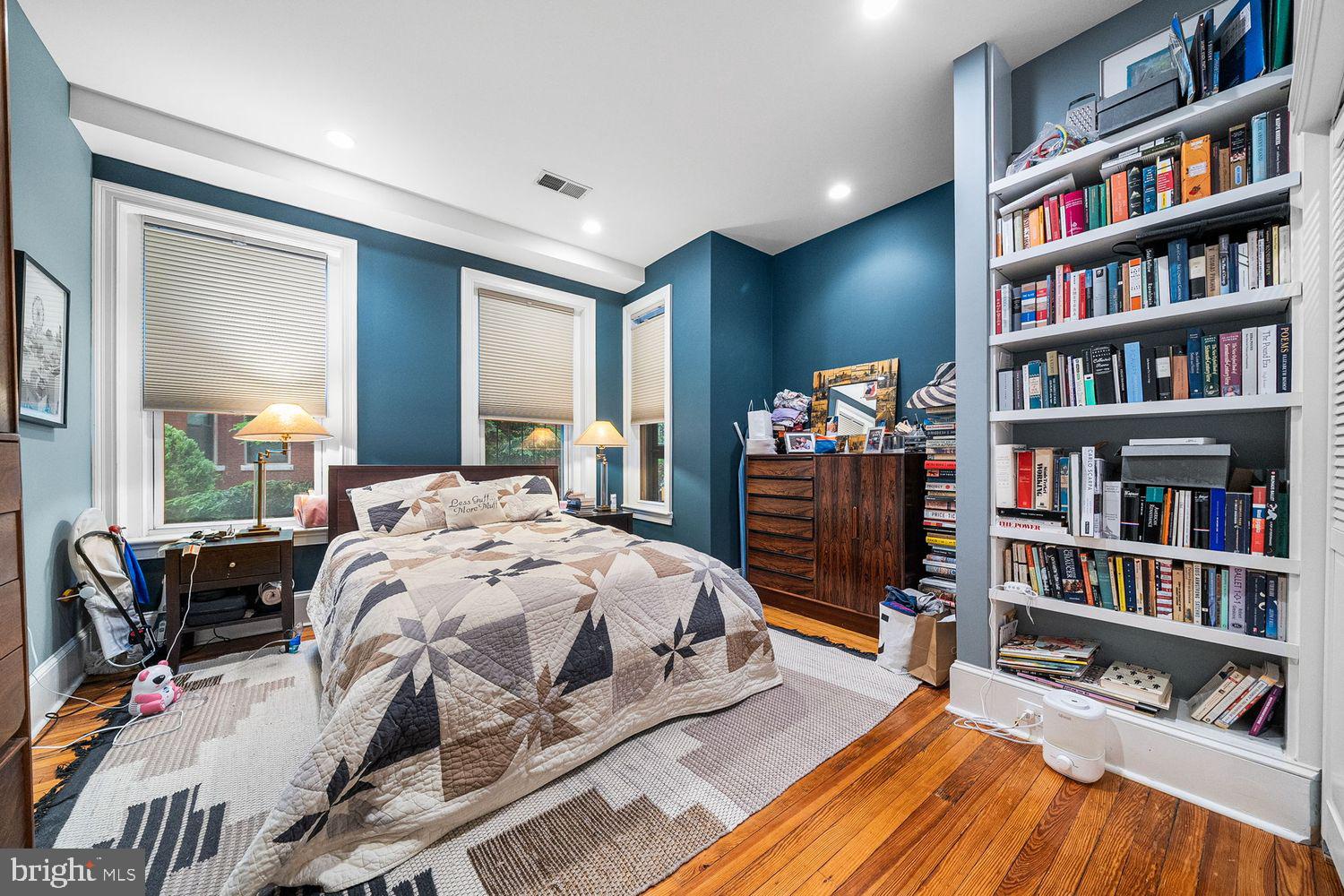 1423 R Street Northwest, Unit 105 Washington, DC 20009 - Photo 17 of 32 a bedroom with a bed furniture and a book shelf