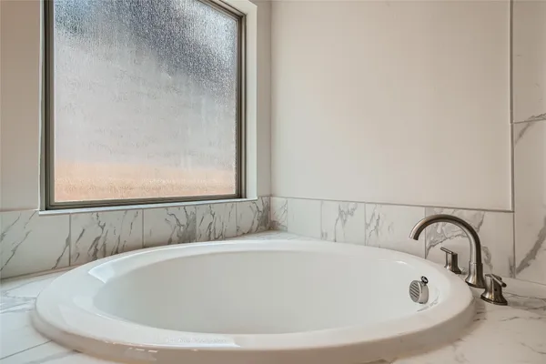 a white bath tub sitting in a bathroom