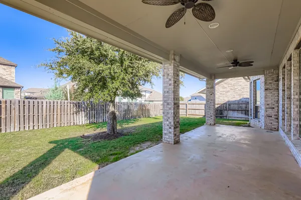 a view of a backyard with porch and garden