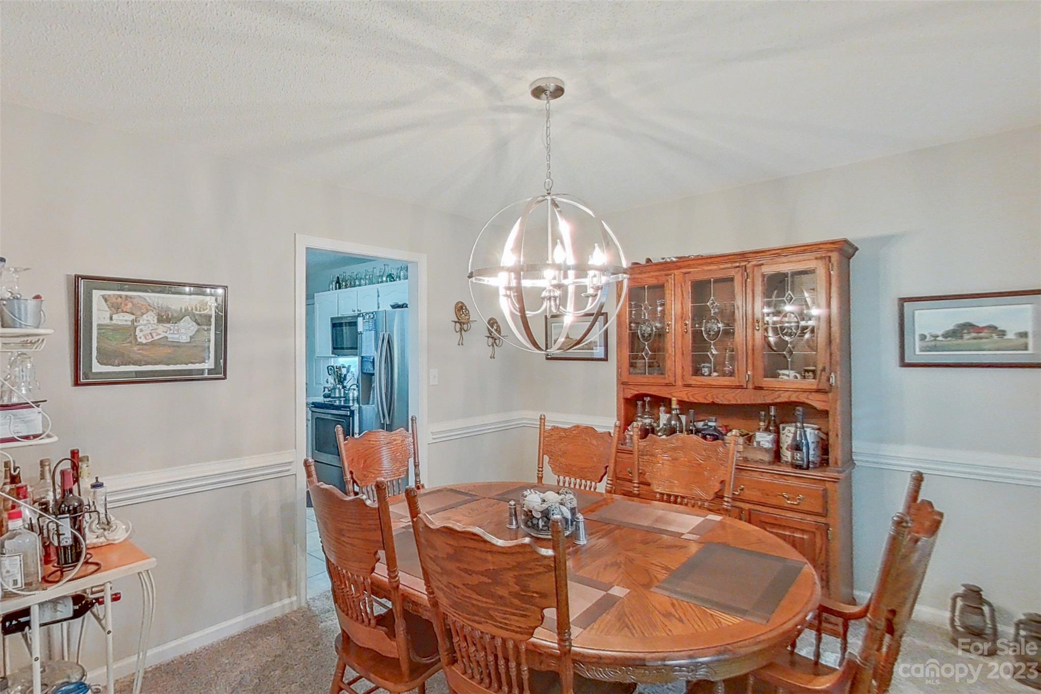 358 Maple Ridge Circle Salisbury, NC 28147 - Photo 11 of 48 a dining room with furniture a chandelier and wooden floor