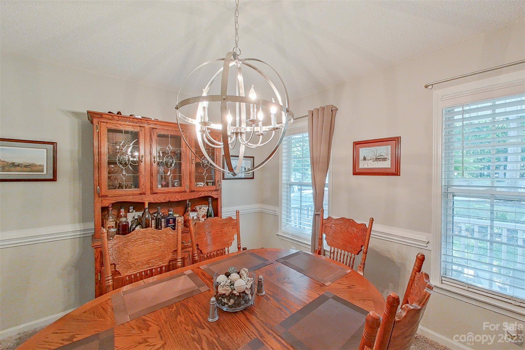 358 Maple Ridge Circle Salisbury, NC 28147 - Photo 12 of 48 a view of a dining room with furniture a chandelier and wooden floor