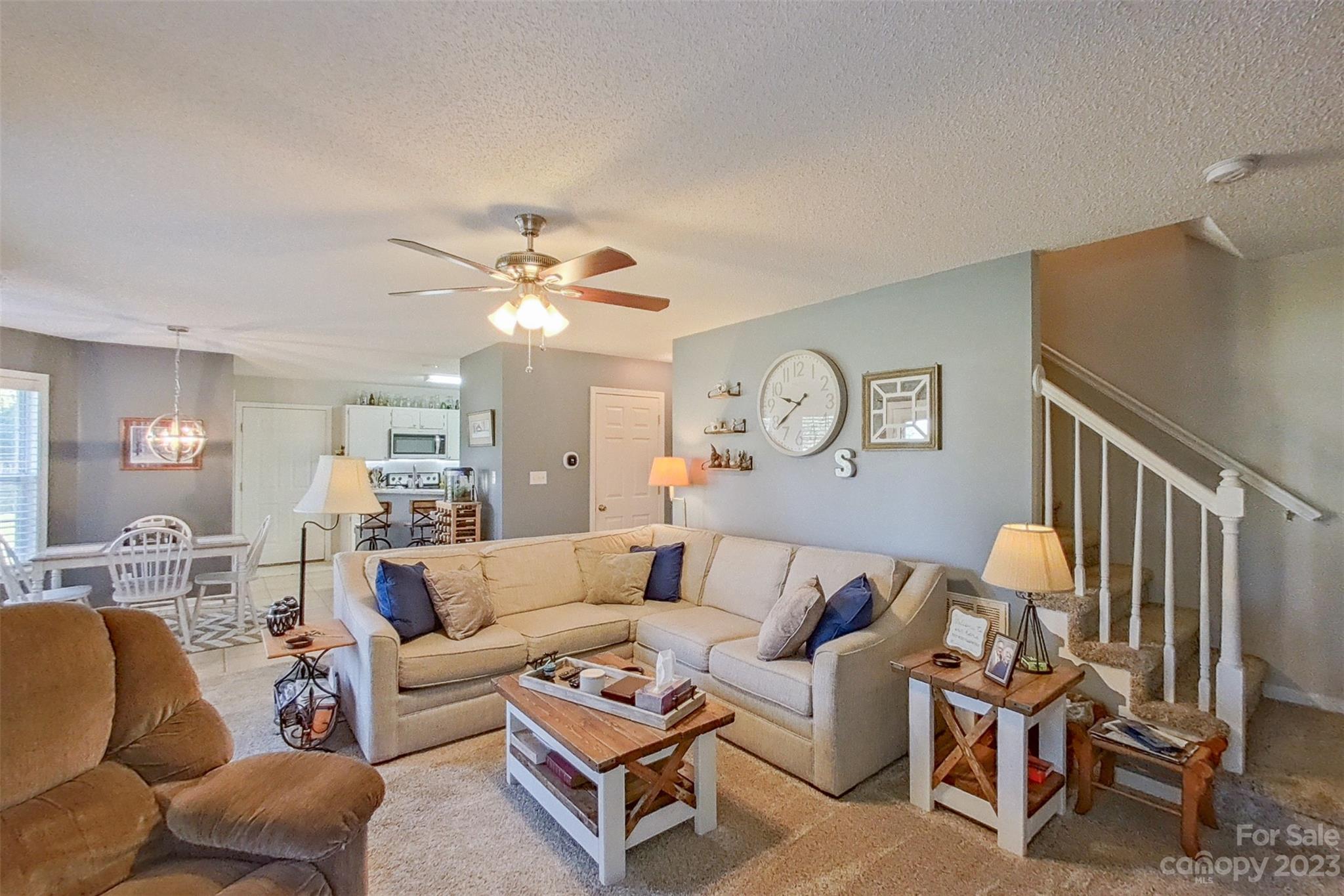 358 Maple Ridge Circle Salisbury, NC 28147 - Photo 16 of 48 a living room with furniture a rug and a chandelier