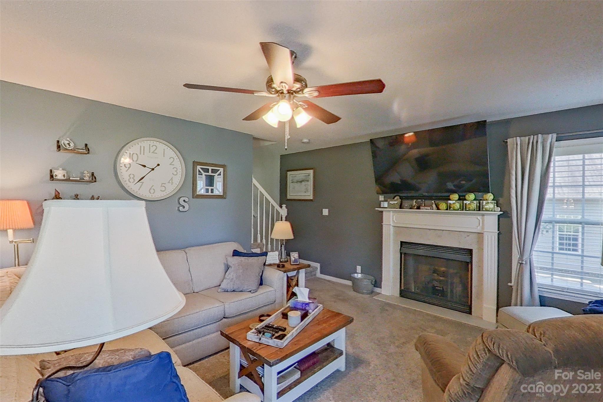 358 Maple Ridge Circle Salisbury, NC 28147 - Photo 17 of 48 a living room with furniture a fireplace and a flat screen tv
