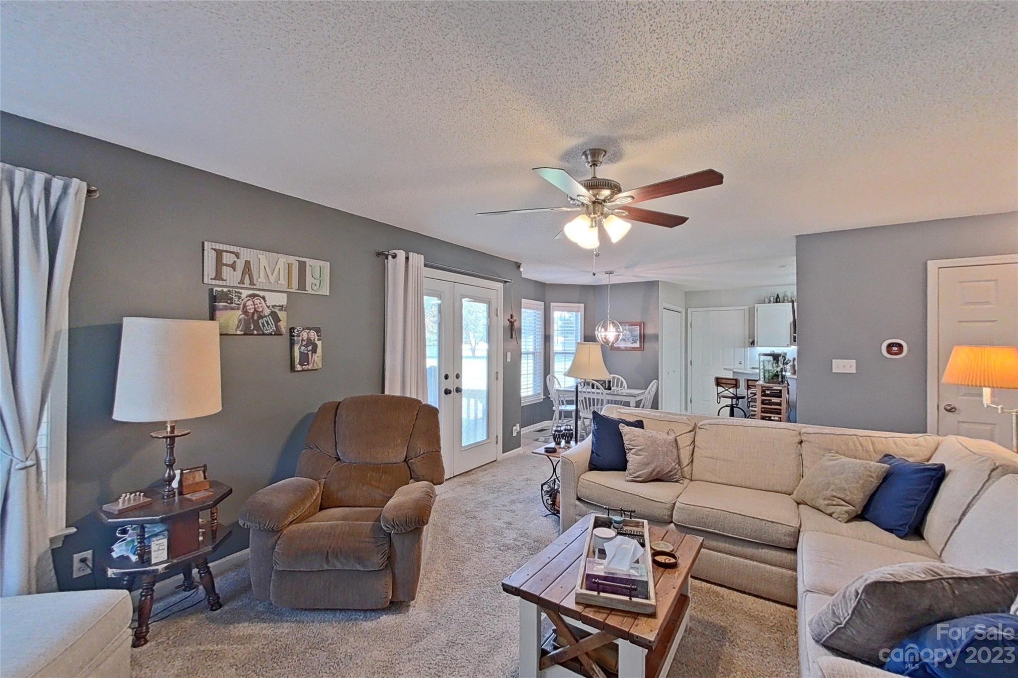 358 Maple Ridge Circle Salisbury, NC 28147 - Photo 18 of 48 a living room with furniture a lamp and a chandelier