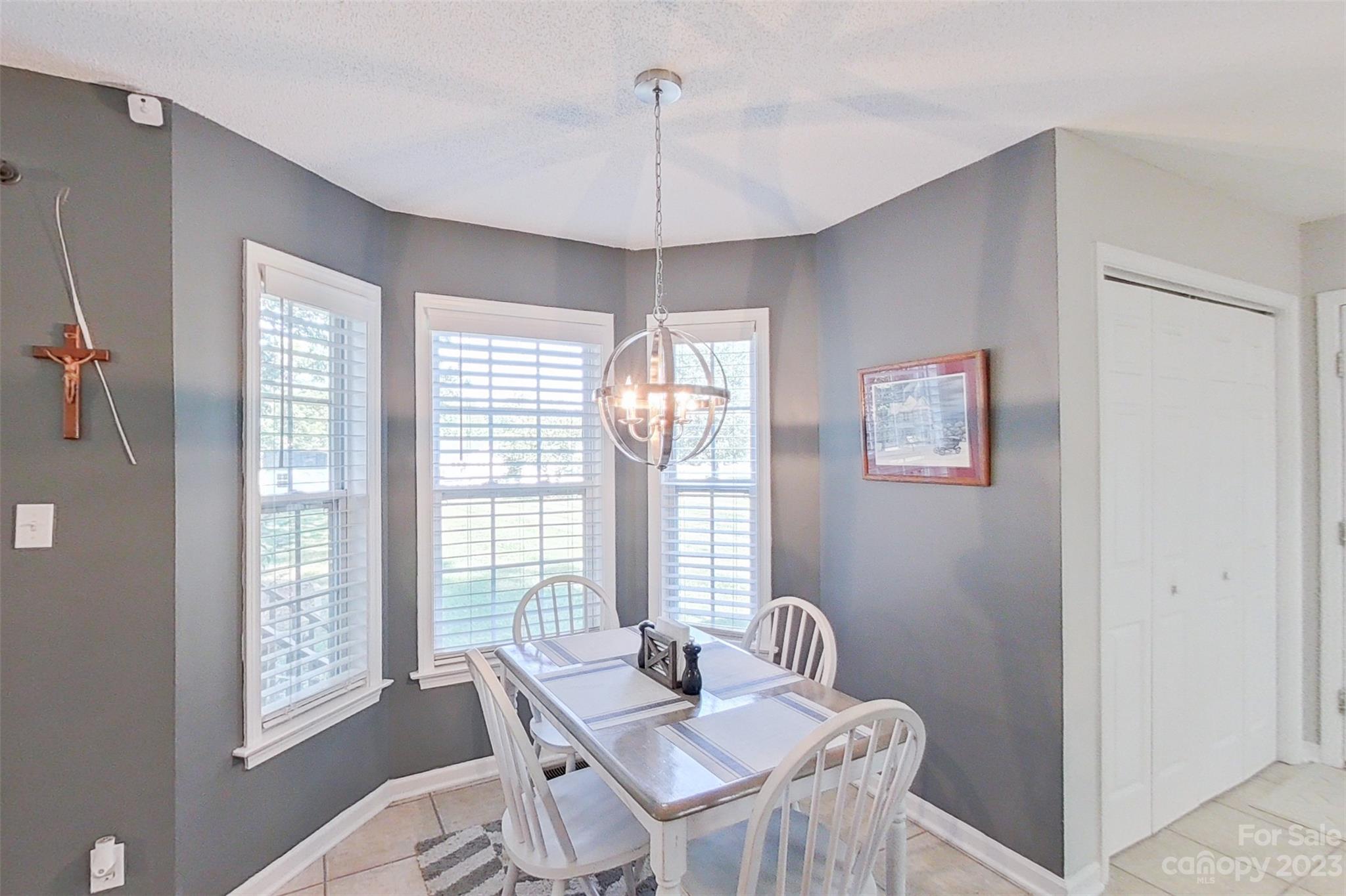 358 Maple Ridge Circle Salisbury, NC 28147 - Photo 20 of 48 a dining room with furniture a chandelier and window