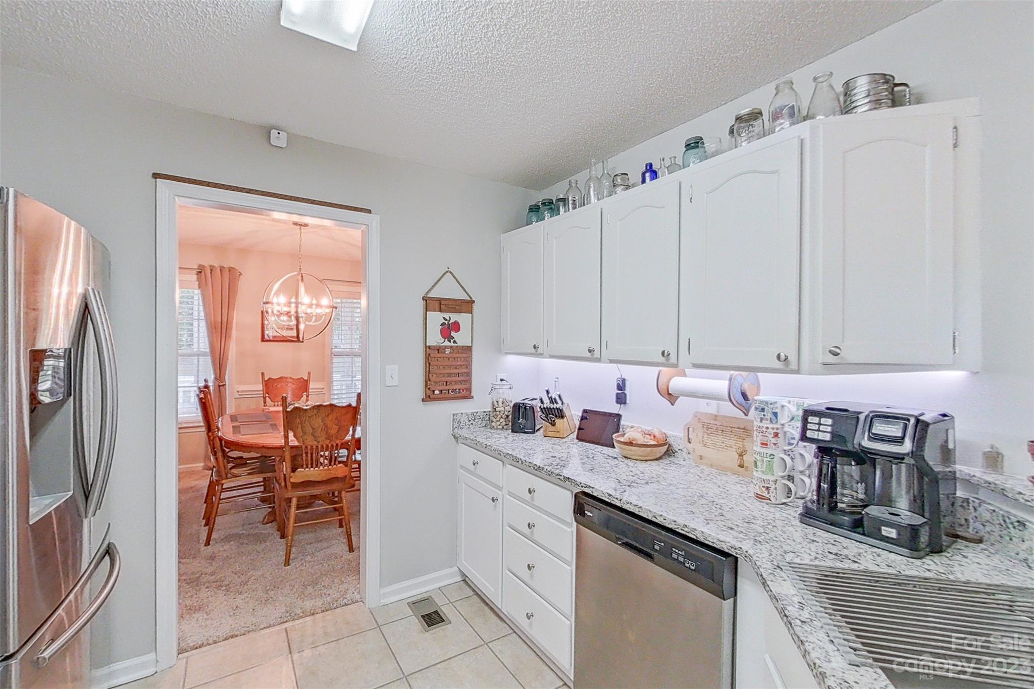 358 Maple Ridge Circle Salisbury, NC 28147 - Photo 22 of 48 a kitchen with stainless steel appliances granite countertop a refrigerator sink and white cabinets
