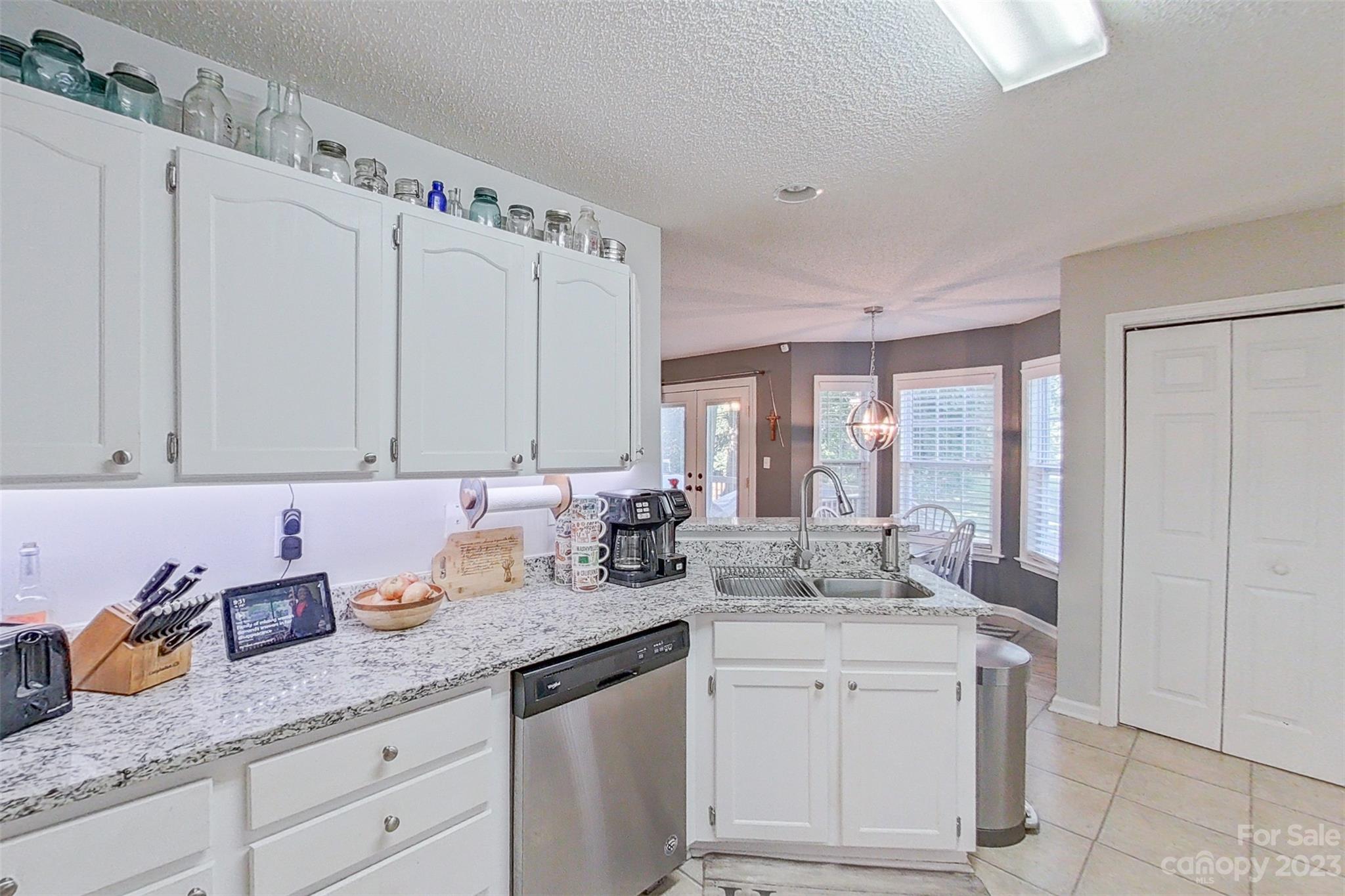 358 Maple Ridge Circle Salisbury, NC 28147 - Photo 23 of 48 a kitchen with granite countertop a sink white cabinets and white appliances