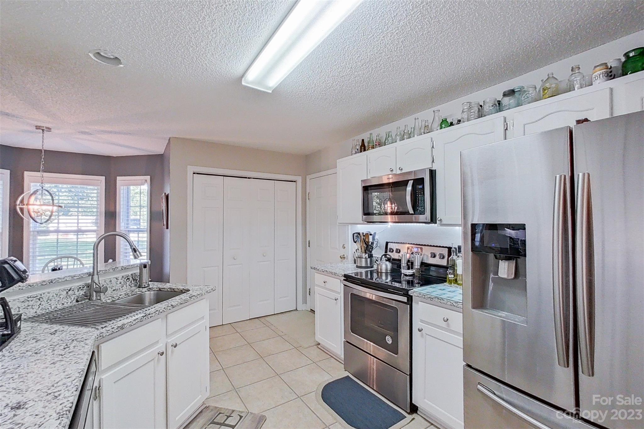 358 Maple Ridge Circle Salisbury, NC 28147 - Photo 24 of 48 a kitchen with granite countertop a refrigerator stove and sink