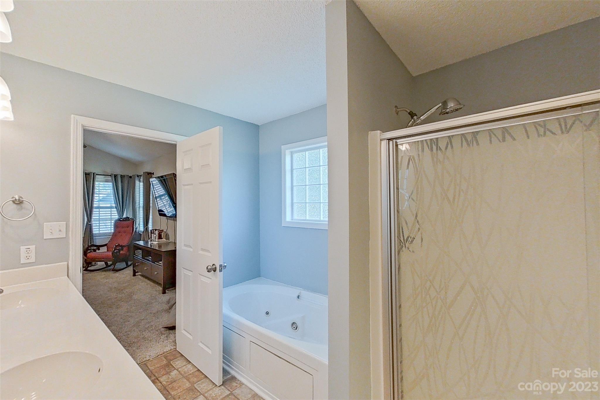 358 Maple Ridge Circle Salisbury, NC 28147 - Photo 30 of 48 a bathroom with a bathtub and a shower
