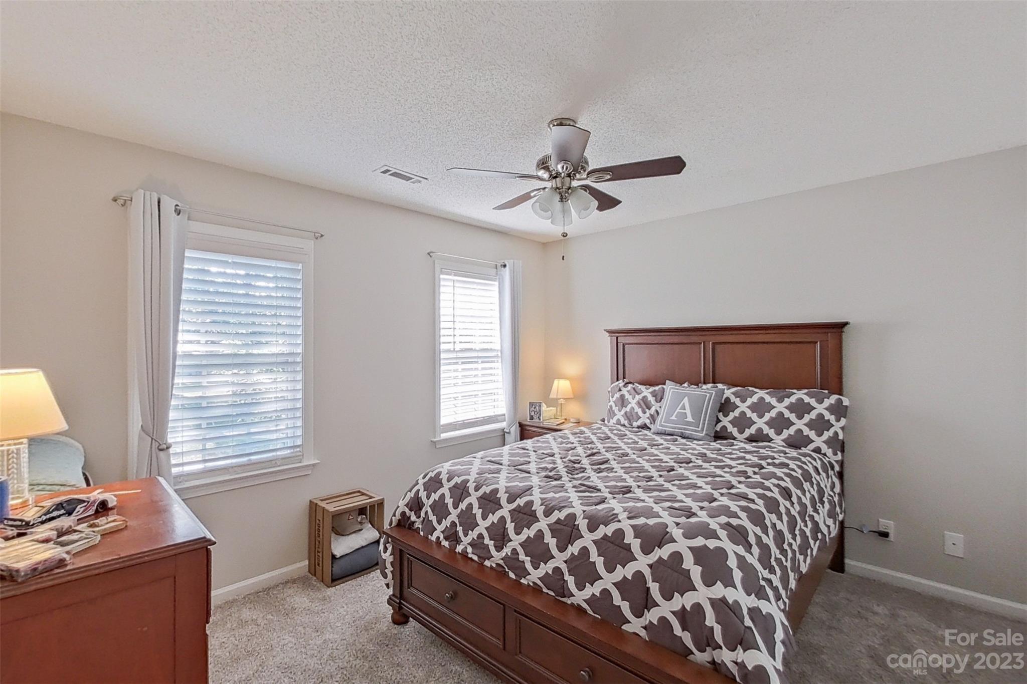 358 Maple Ridge Circle Salisbury, NC 28147 - Photo 31 of 48 a bedroom with a bed and a chandelier