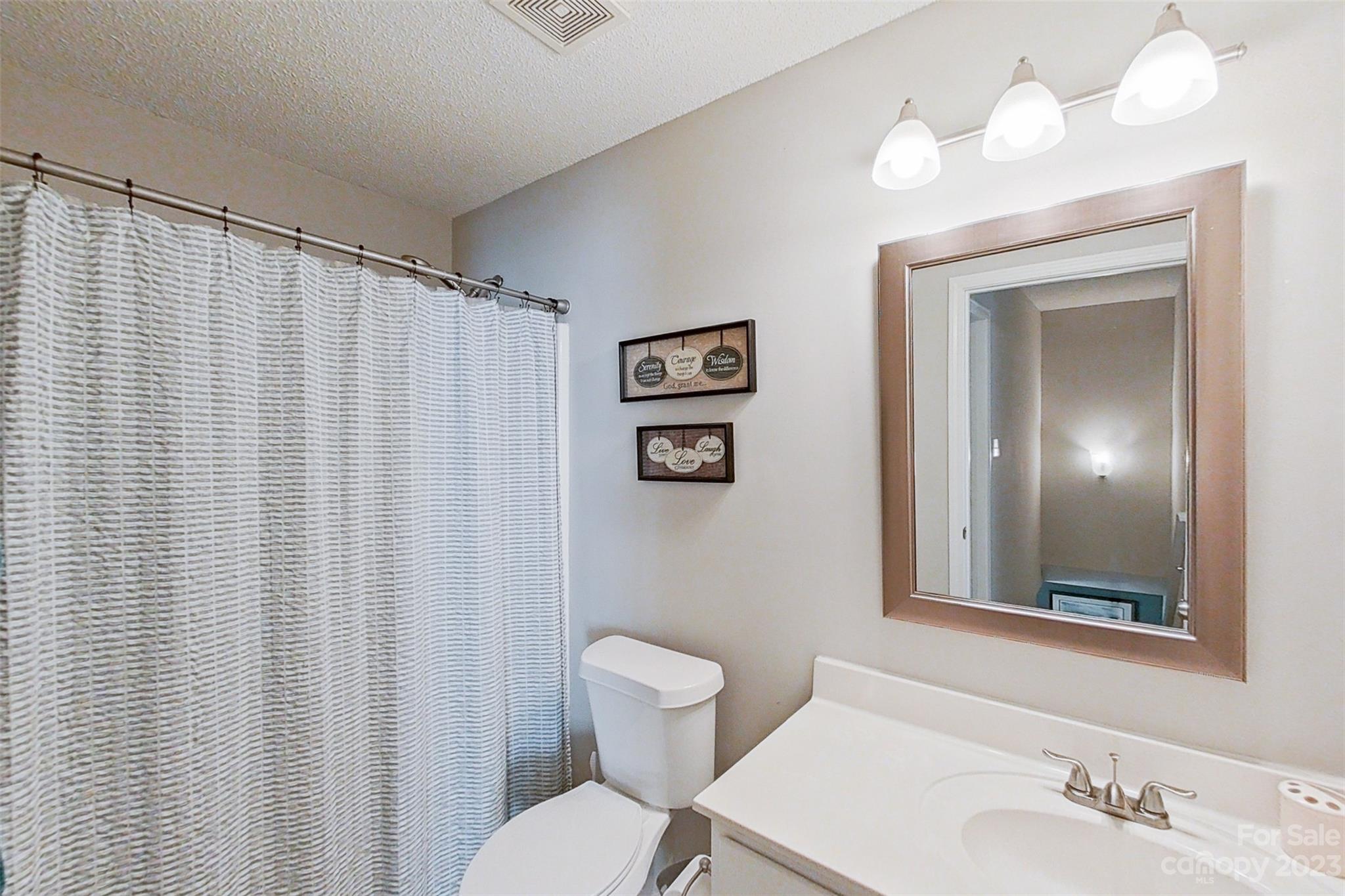 358 Maple Ridge Circle Salisbury, NC 28147 - Photo 34 of 48 a bathroom with a toilet a sink and a mirror