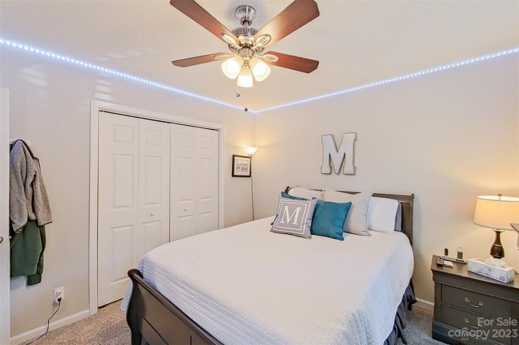 358 Maple Ridge Circle Salisbury, NC 28147 - Photo 37 of 48 a bedroom with a bed and a chandelier