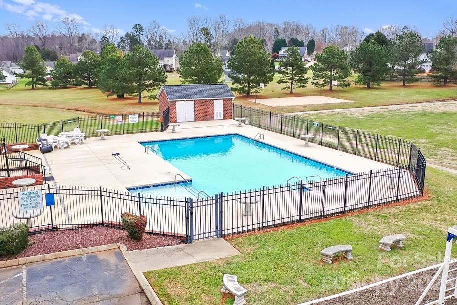 358 Maple Ridge Circle Salisbury, NC 28147 - Photo 47 of 48 a view of a swimming pool with a lawn chairs and a yard