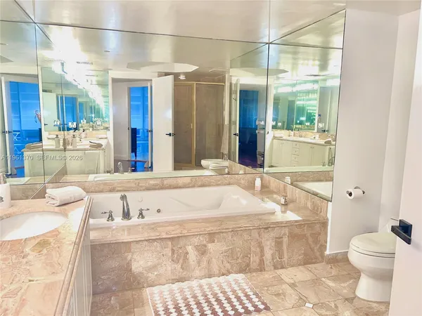 a bathroom with a tub sink and toilet