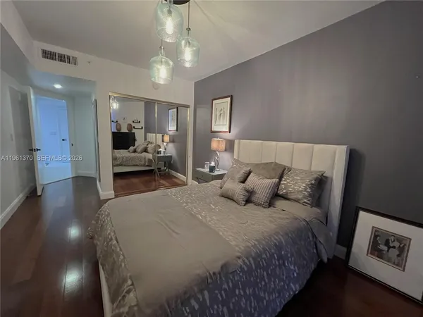 a bed room with a bed and a television