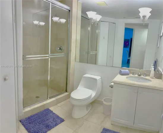 a bathroom with a toilet a sink and shower
