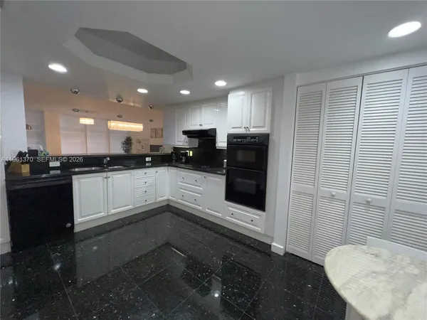 a view of a kitchen with electric appliances