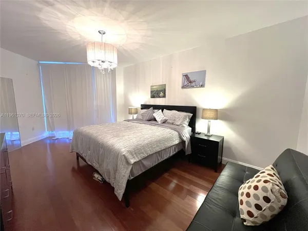 a bedroom with a bed and a chair
