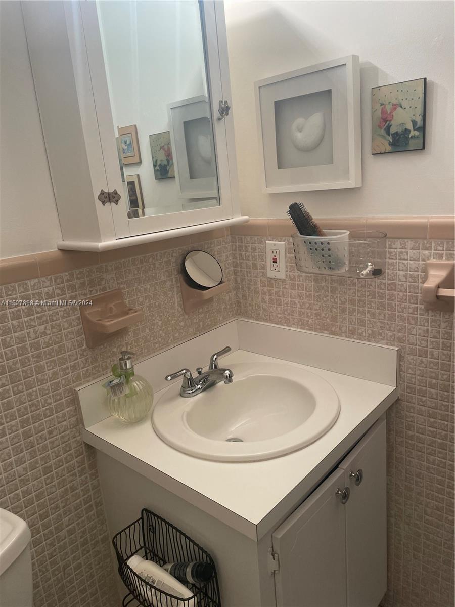 Biscayne Point Miami Beach, FL 33141 - Photo 4 of 4 a bathroom with a sink and a mirror