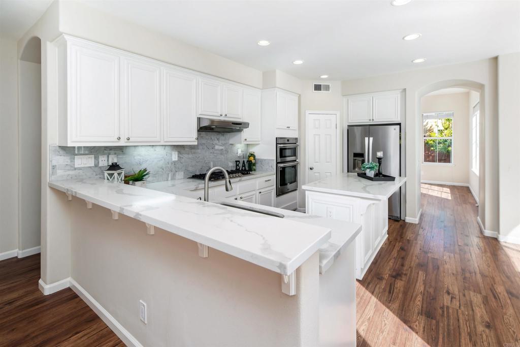 1577 Archer Road San Marcos, CA 92078 - Photo 12 of 53 a kitchen with stainless steel appliances sink refrigerator microwave and stove