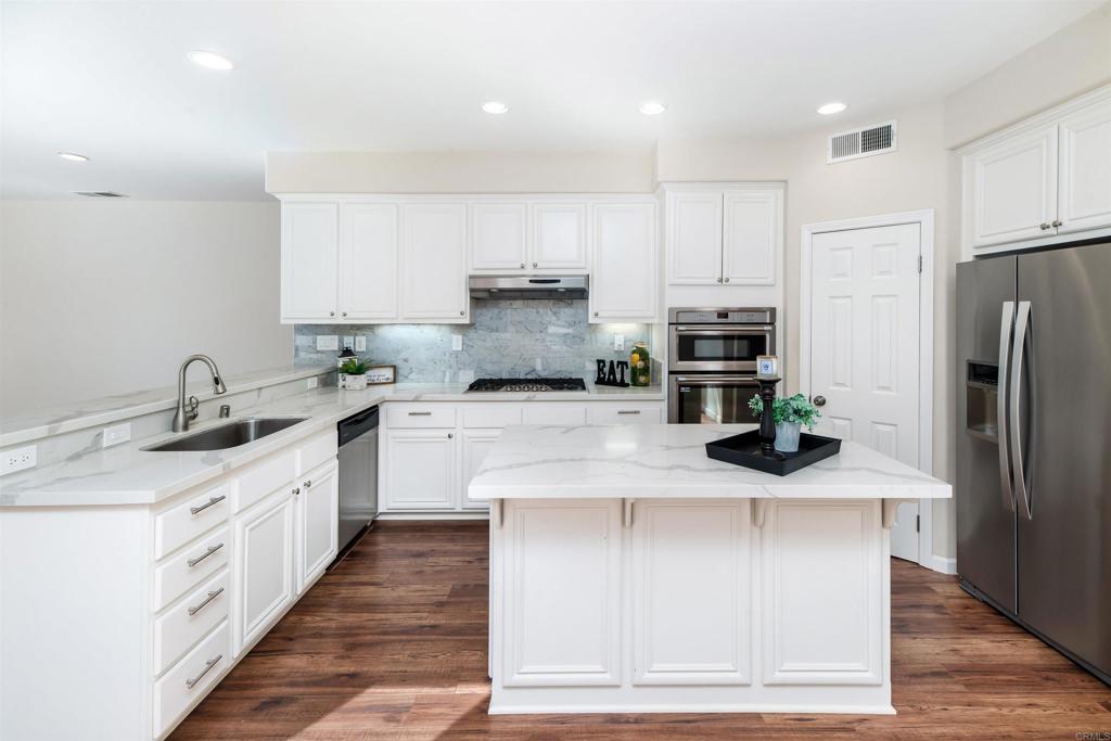 1577 Archer Road San Marcos, CA 92078 - Photo 13 of 53 a large kitchen with stainless steel appliances granite countertop a sink a stove and a refrigerator