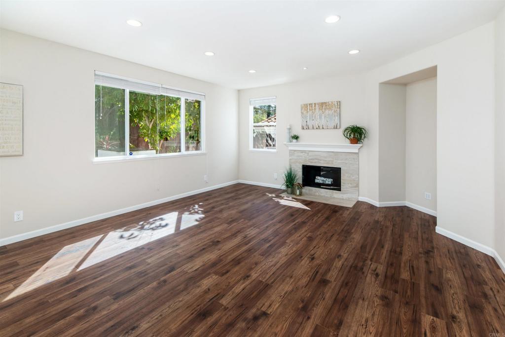 1577 Archer Road San Marcos, CA 92078 - Photo 18 of 53 a view of an empty room with wooden floor fireplace and a window