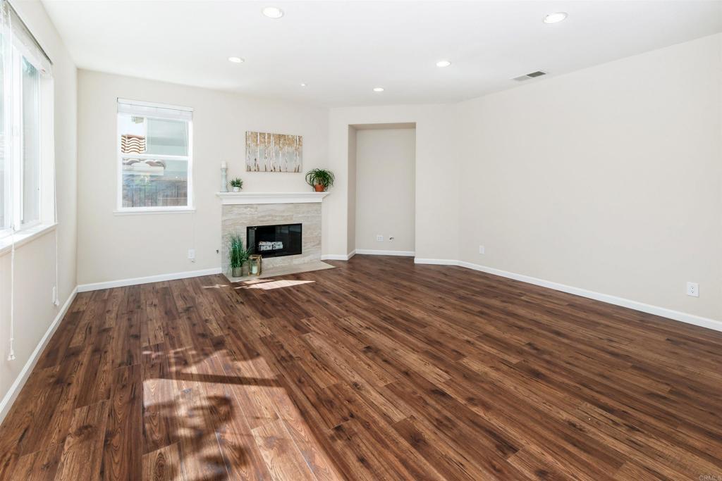 1577 Archer Road San Marcos, CA 92078 - Photo 19 of 53 a view of empty room with fireplace and wooden floor