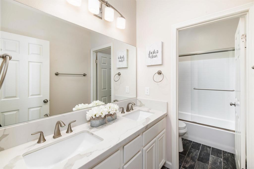 1577 Archer Road San Marcos, CA 92078 - Photo 33 of 53 a bathroom with a granite countertop sink mirror toilet and shower