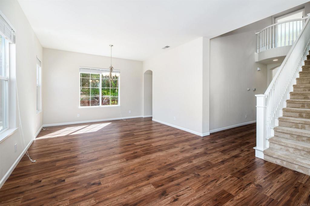 1577 Archer Road San Marcos, CA 92078 - Photo 7 of 53 a view of an empty room with wooden floor and a window