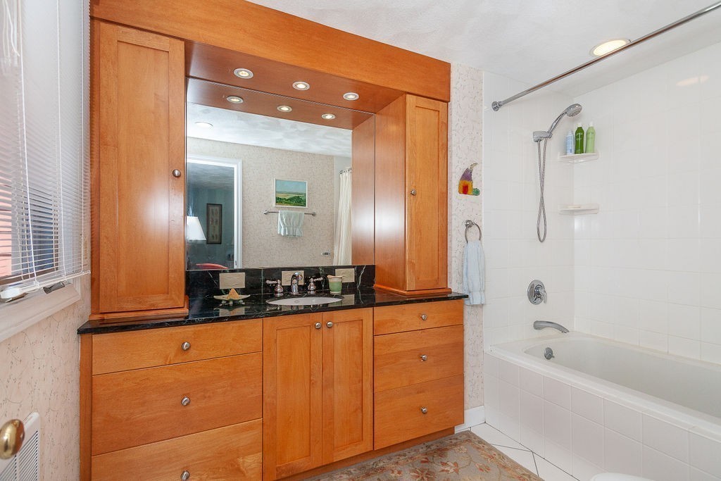 3 Potter Pond, Unit 3 Lexington, MA 02421 - Photo 11 of 20 a bathroom with a bathtub sink vanity and mirror