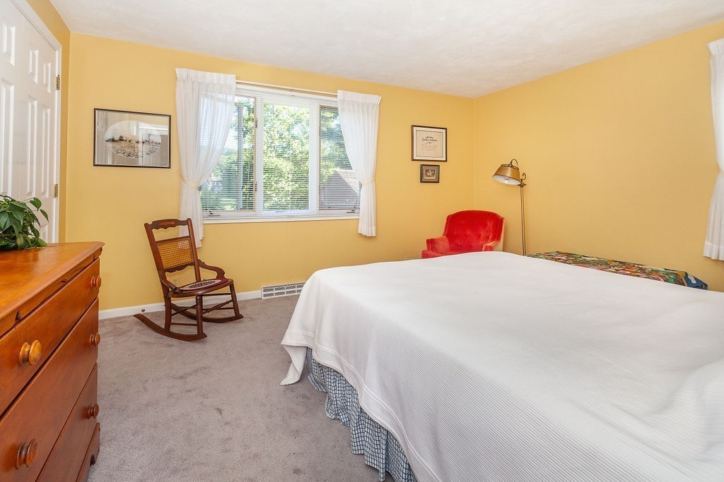 3 Potter Pond, Unit 3 Lexington, MA 02421 - Photo 13 of 20 a bedroom with a bed and a window