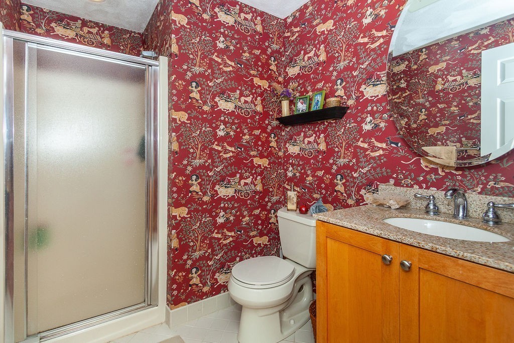 3 Potter Pond, Unit 3 Lexington, MA 02421 - Photo 14 of 20 a bathroom with a granite countertop toilet sink and mirror